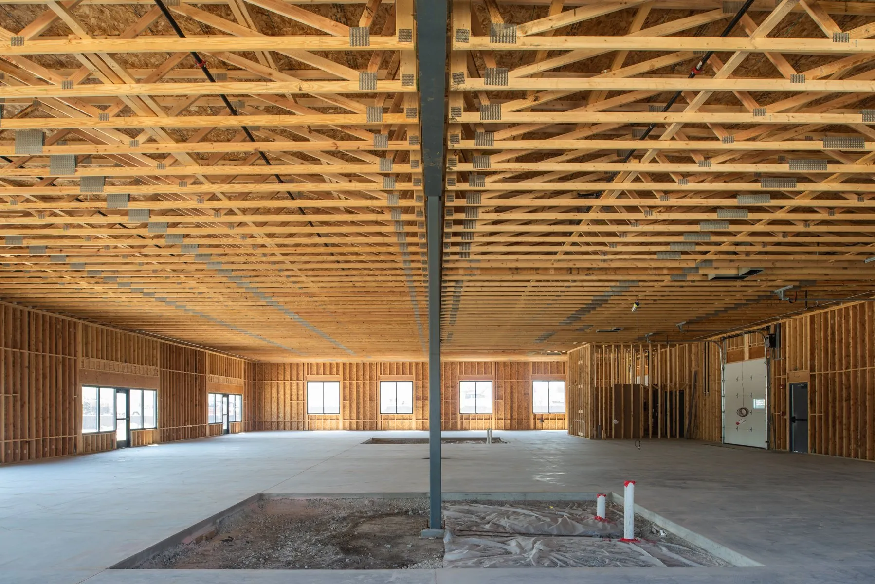 Warehouse interior with exposed timber trusses, 3800 SE Beisser, Grimes, Iowa
