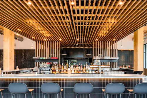 Modern café counter beneath a wood-slat ceiling