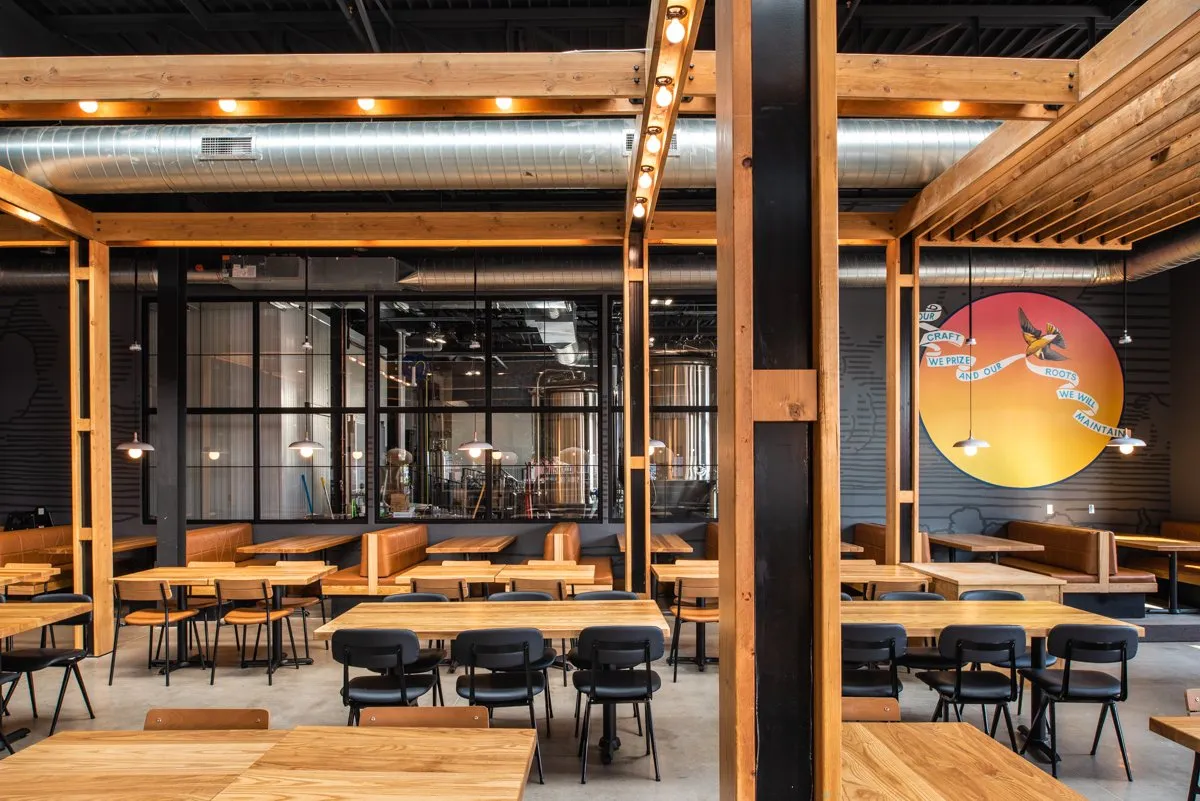 Big Grove Brewery taproom interior with timber beams and an open bar, Des Moines