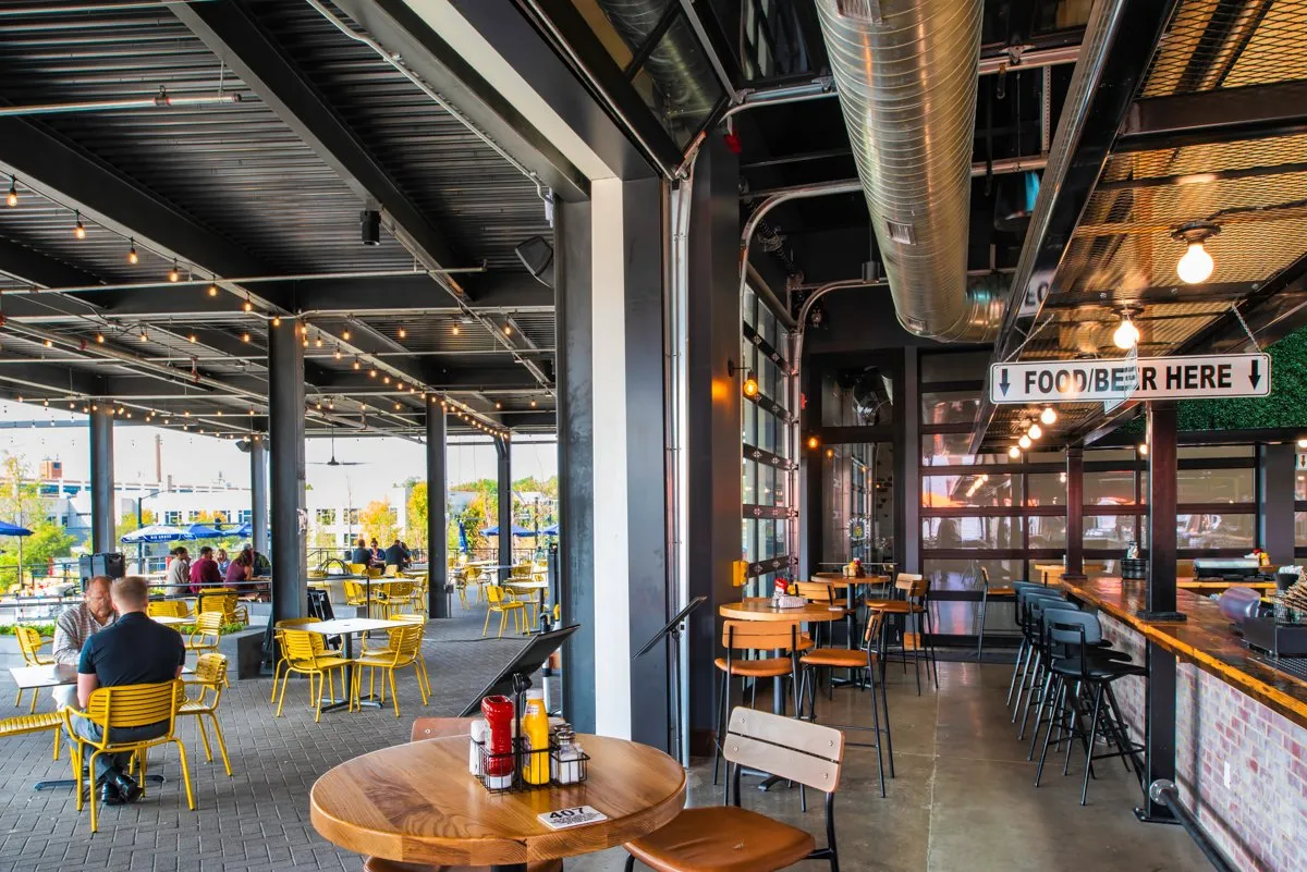 Big Grove Brewery taproom interior with timber beams and an open bar, Des Moines