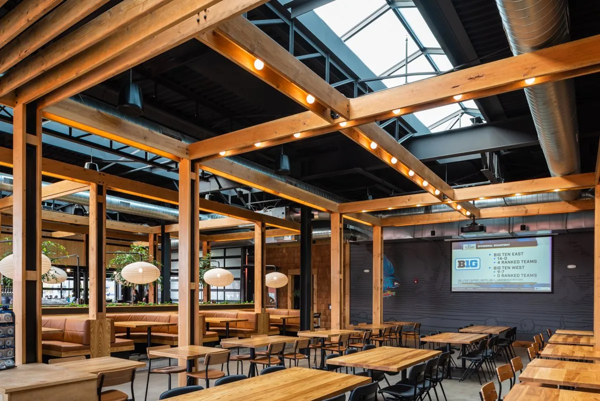 Big Grove Brewery taproom interior with timber beams and an open bar, Des Moines
