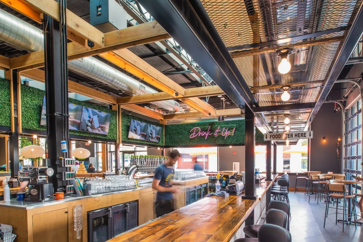 Big Grove Brewery taproom interior with timber beams and an open bar, Des Moines