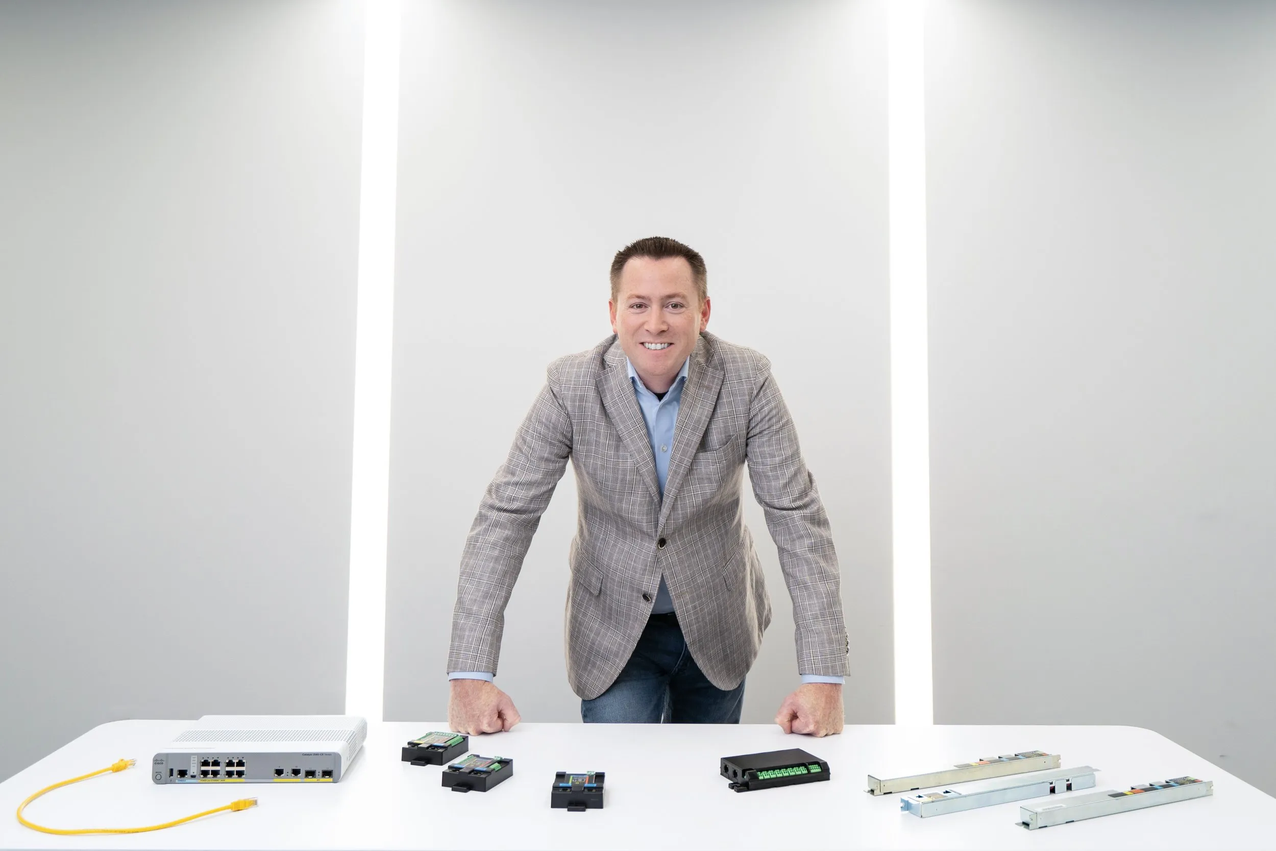 IGOR team member presenting Power over Ethernet products on a white table