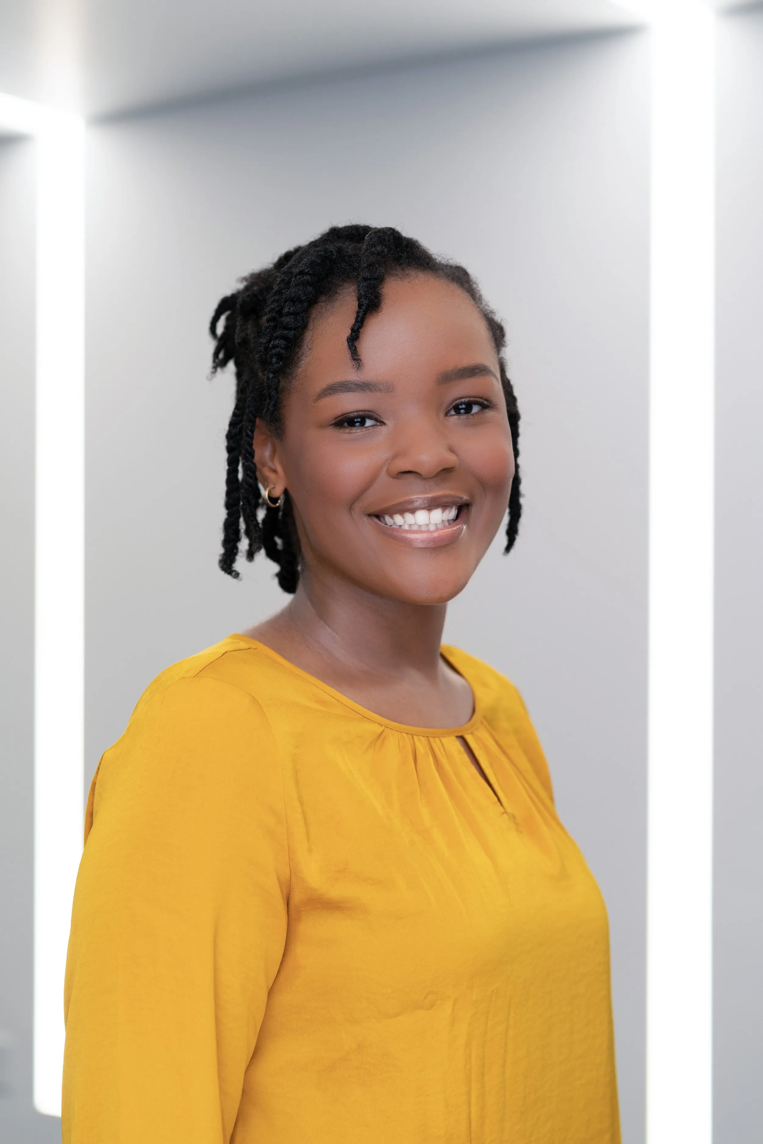 Professional headshot of an IGOR team member in a yellow sweater