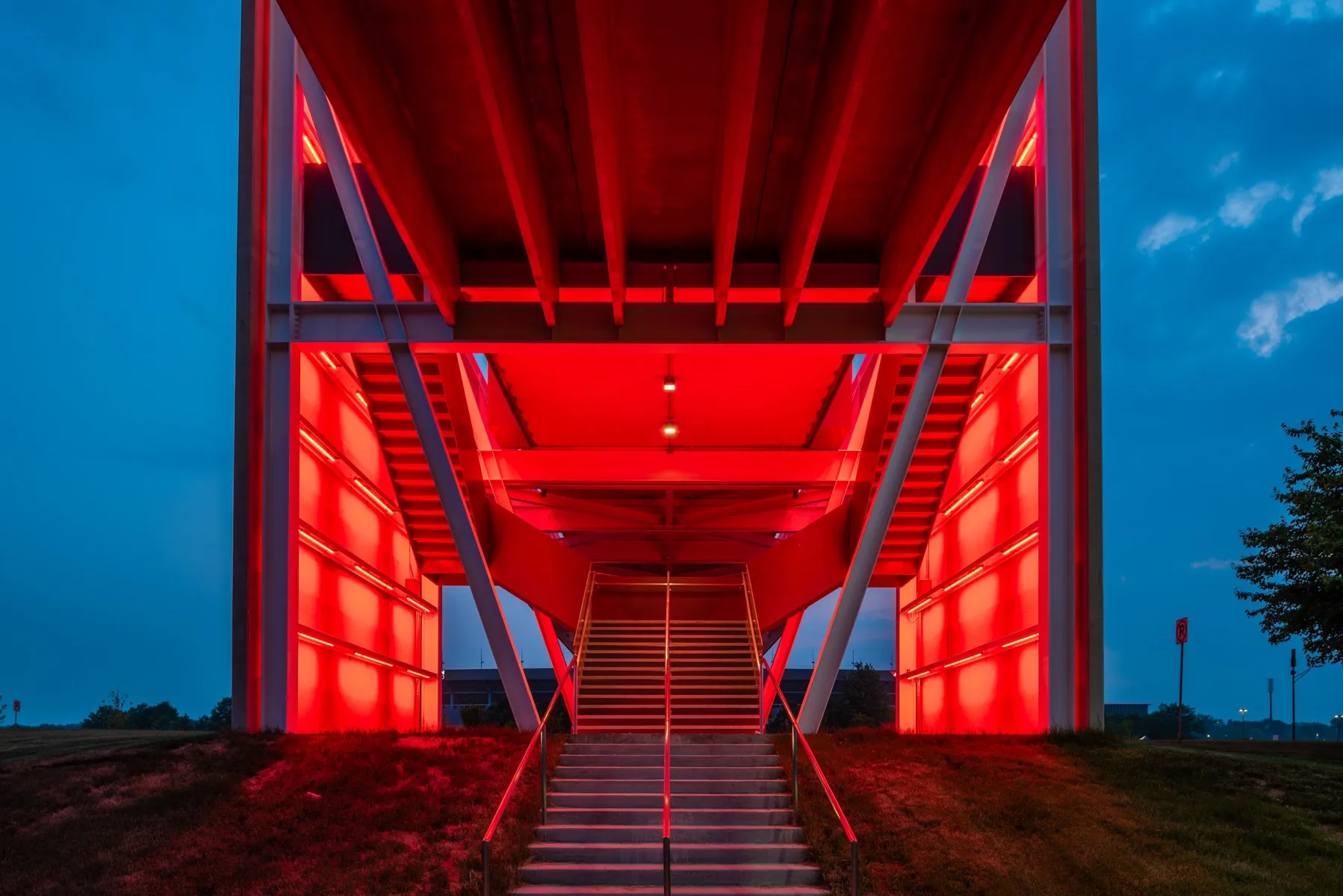 Inside the red-lit ISU Gateway Bridge at twilight