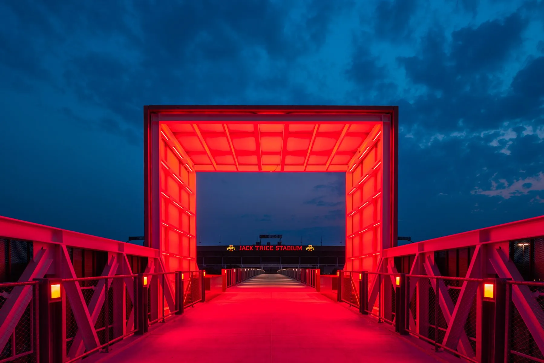 ISU Gateway Bridge lit in red at night, Ames, Iowa