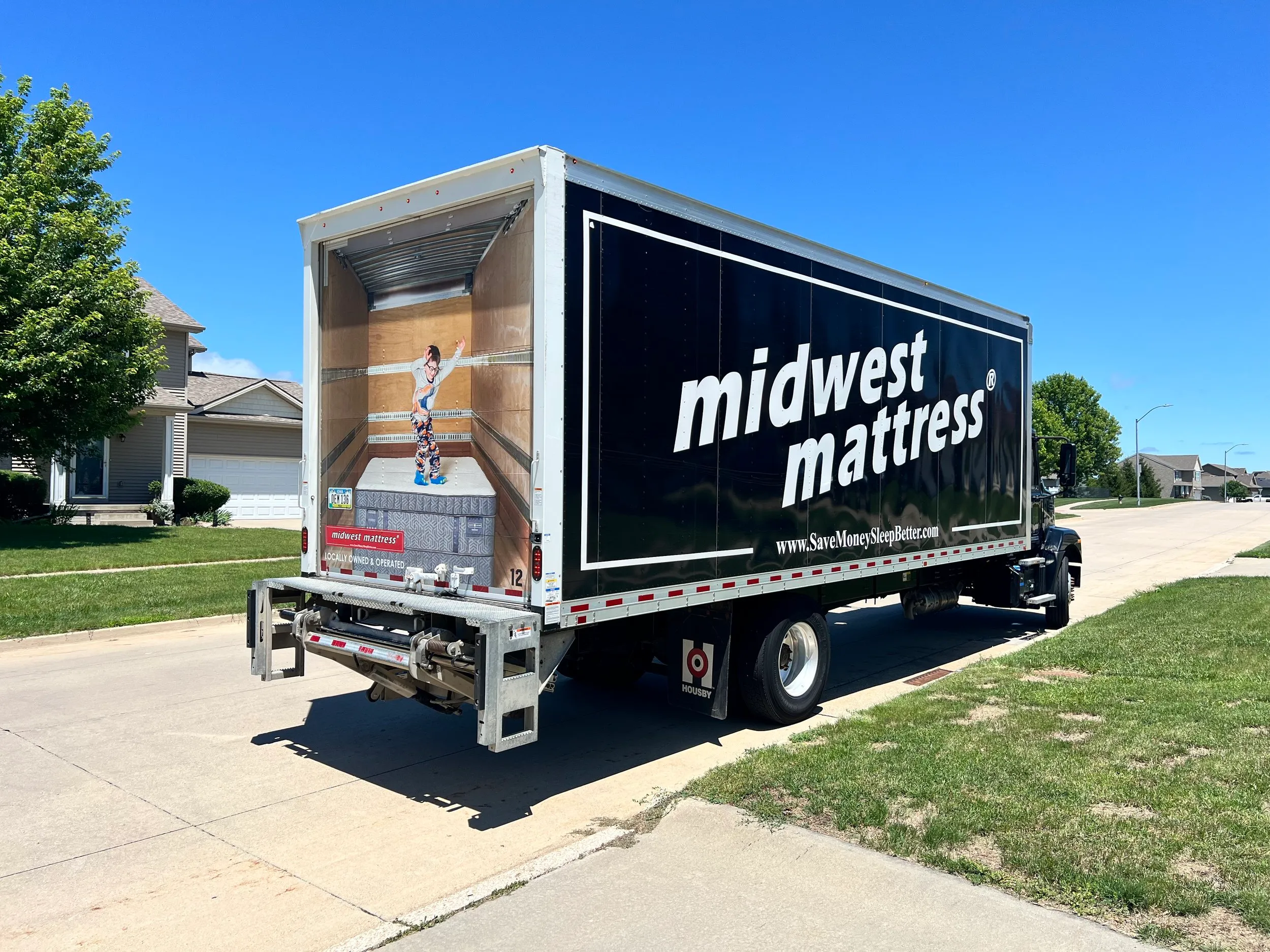 Midwest Mattress box truck parked in a residential neighborhood