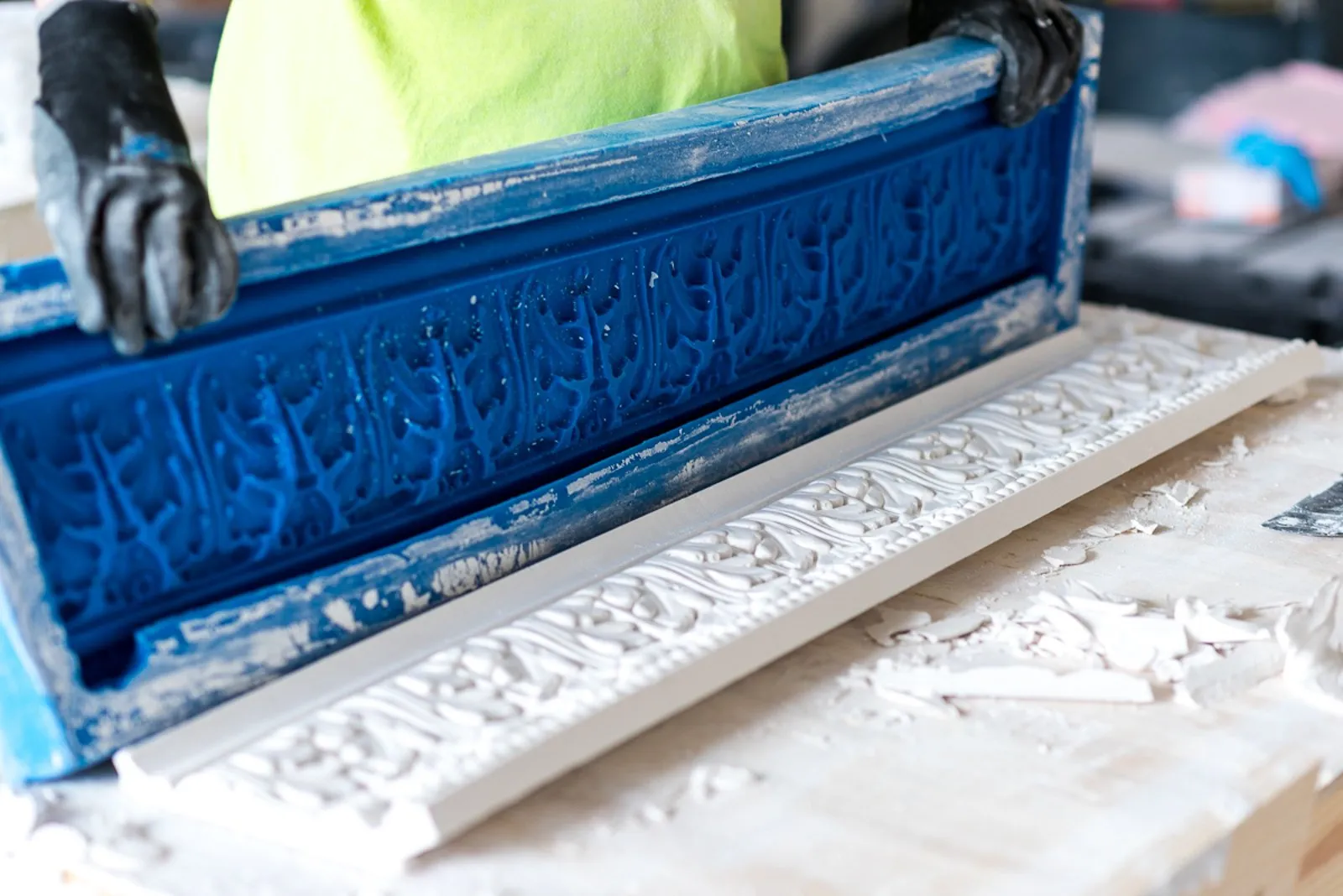Worker restoring a decorative plaster casting