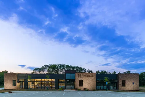 Modern low building at dusk under a deep blue sky