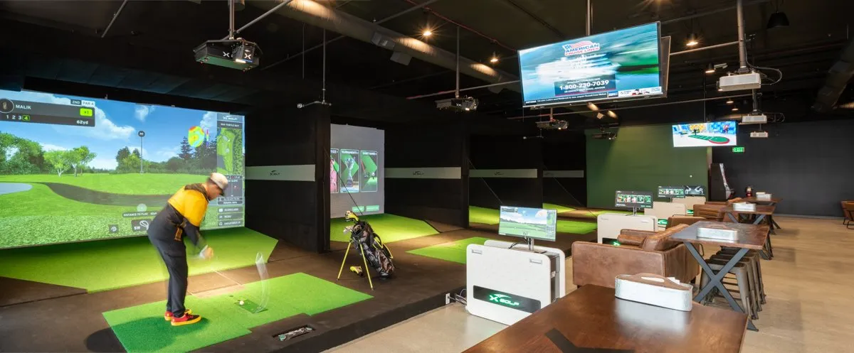X-Golf simulator lounge with swing bays